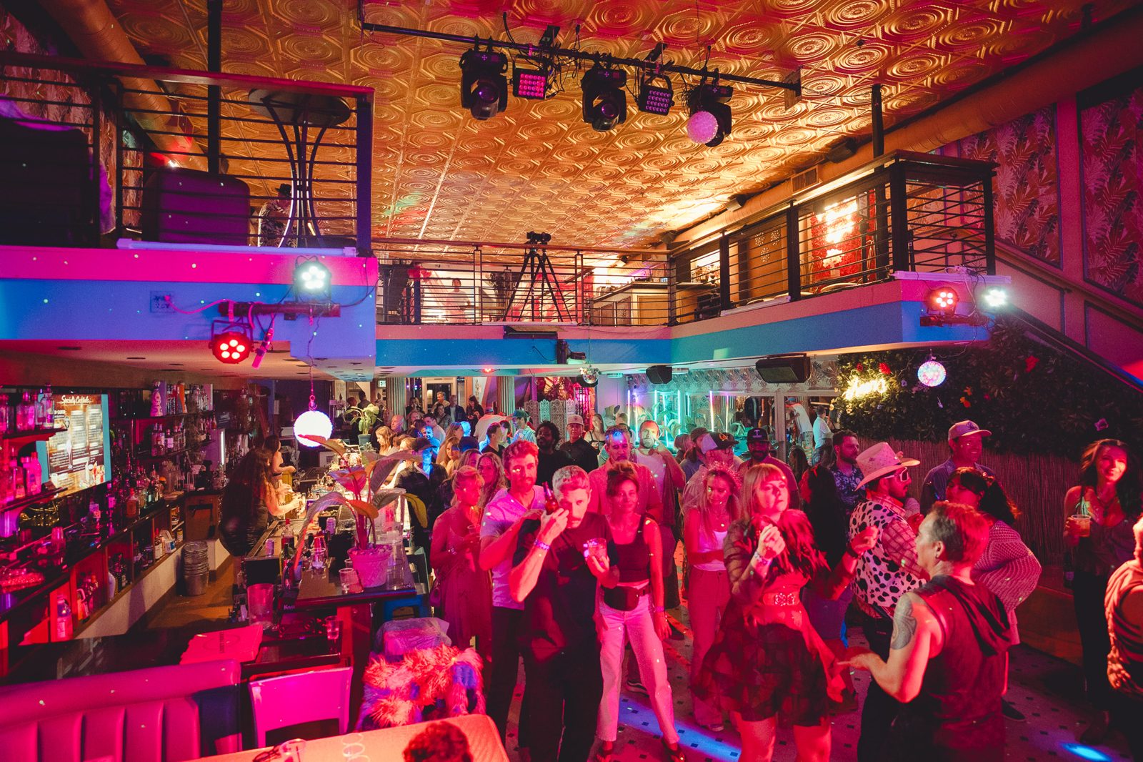 Packed dancefloor in pink light