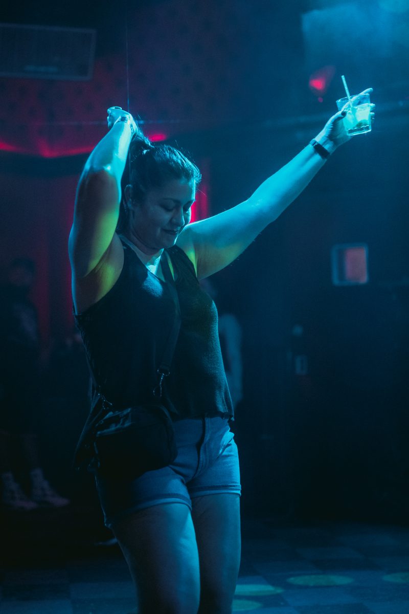 Silhouetted dancer with hands up