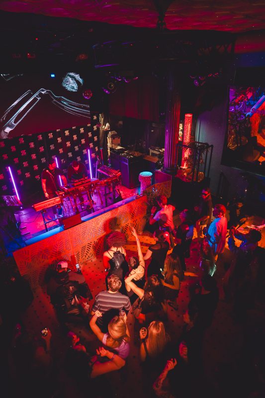 Neon-lit venue during a set